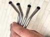 Bent-Steel-Straws-in-Hand-Detail